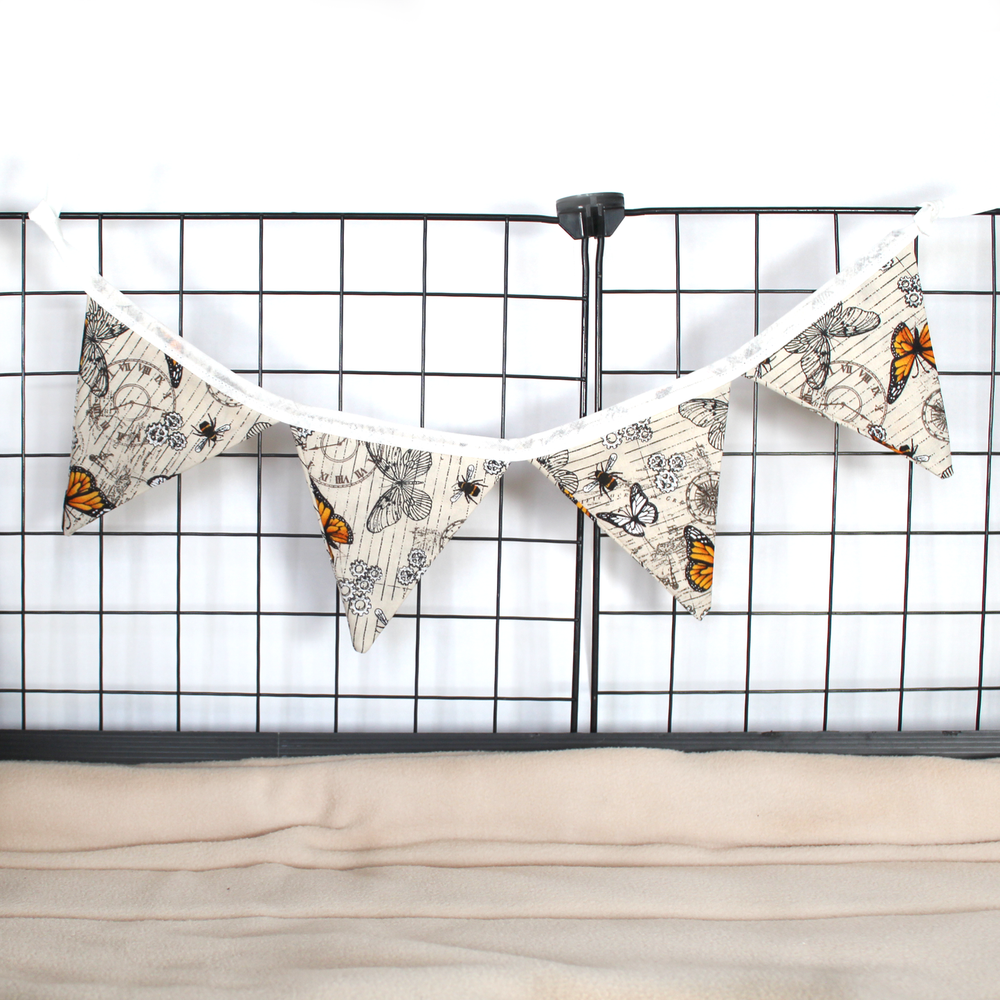Small Steampunk Butterfly Bunting, hung from a guinea pig cage