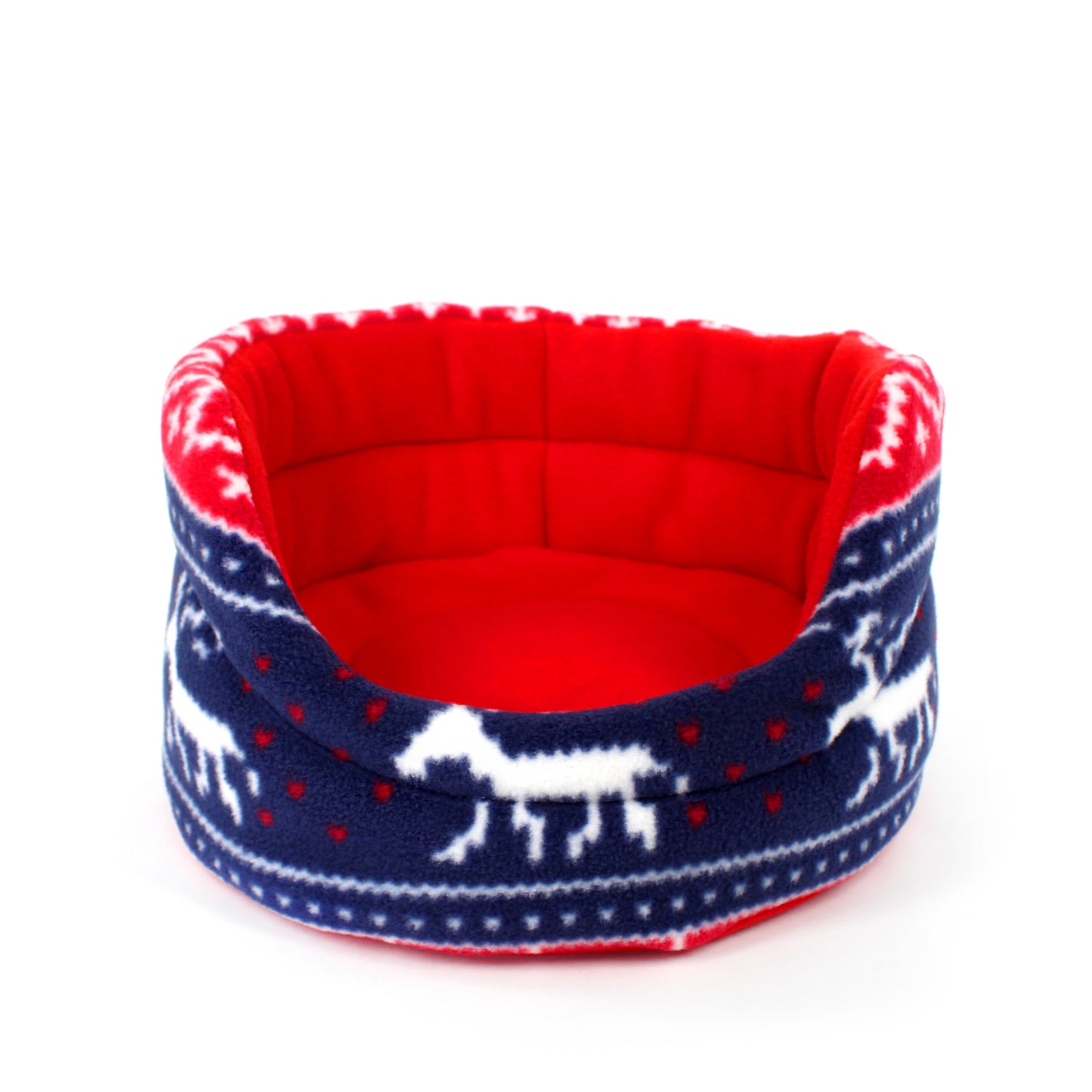 Red and blue pet bed with reindeer pattern on a white background