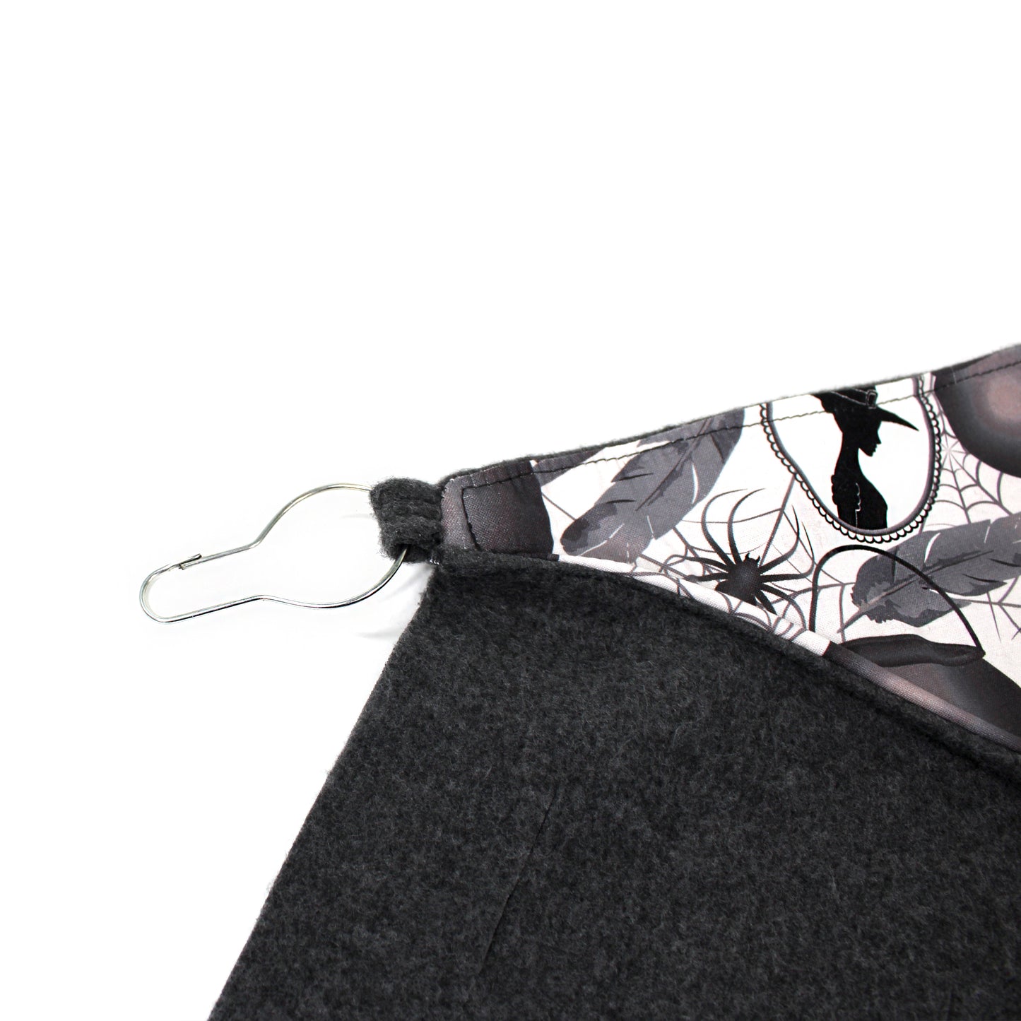 Black fabric with a spider web pattern on a white background