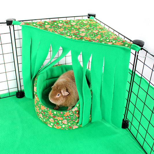 Pet cage with a green hammock and floral cushion, featuring a small animal.