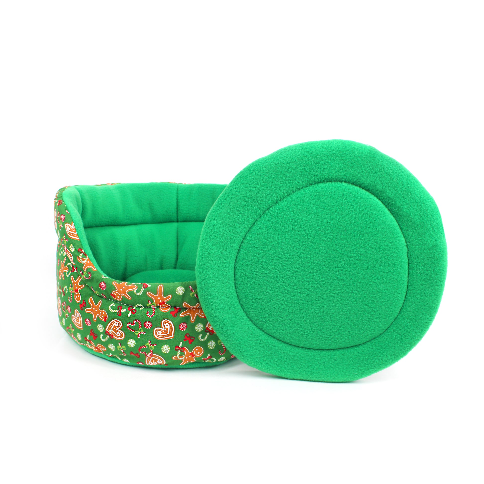 Green pet bed with floral pattern and matching green lid on a white background