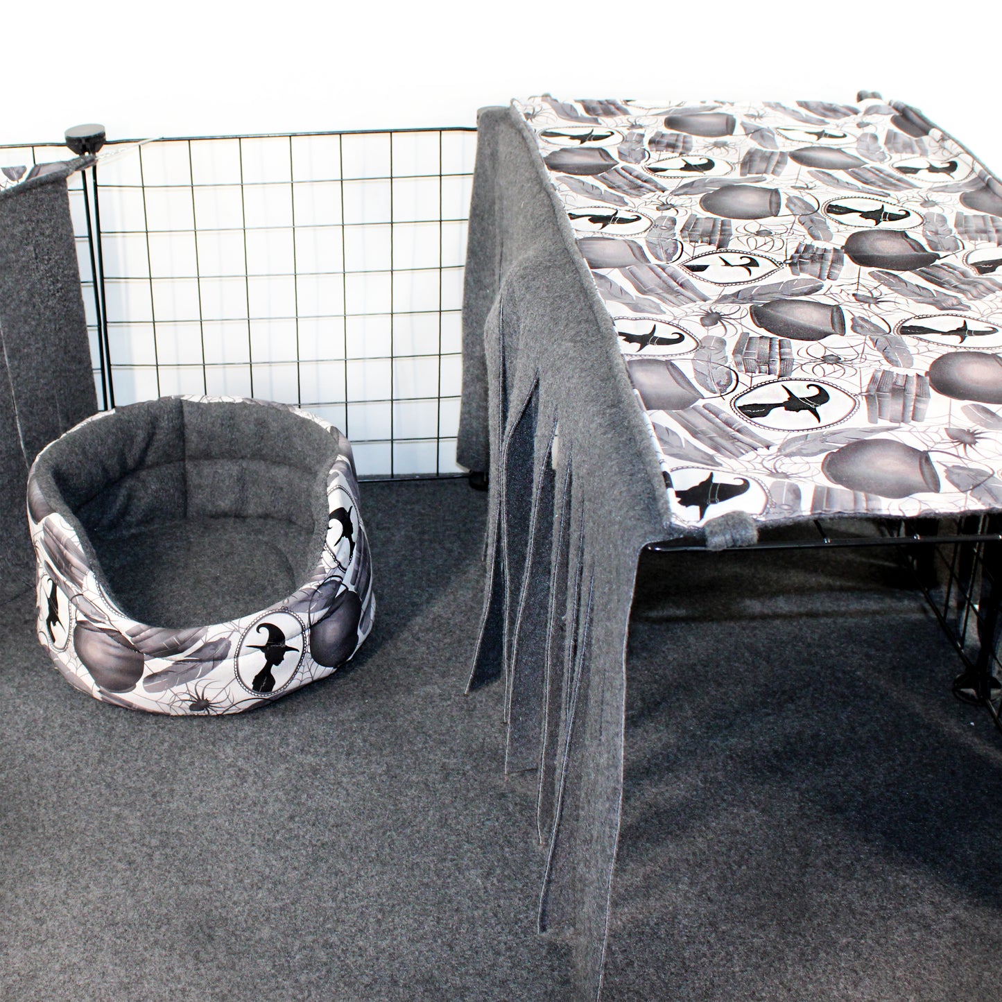 Cat bed with airplane pattern next to a table with a similar pattern in a room setting.