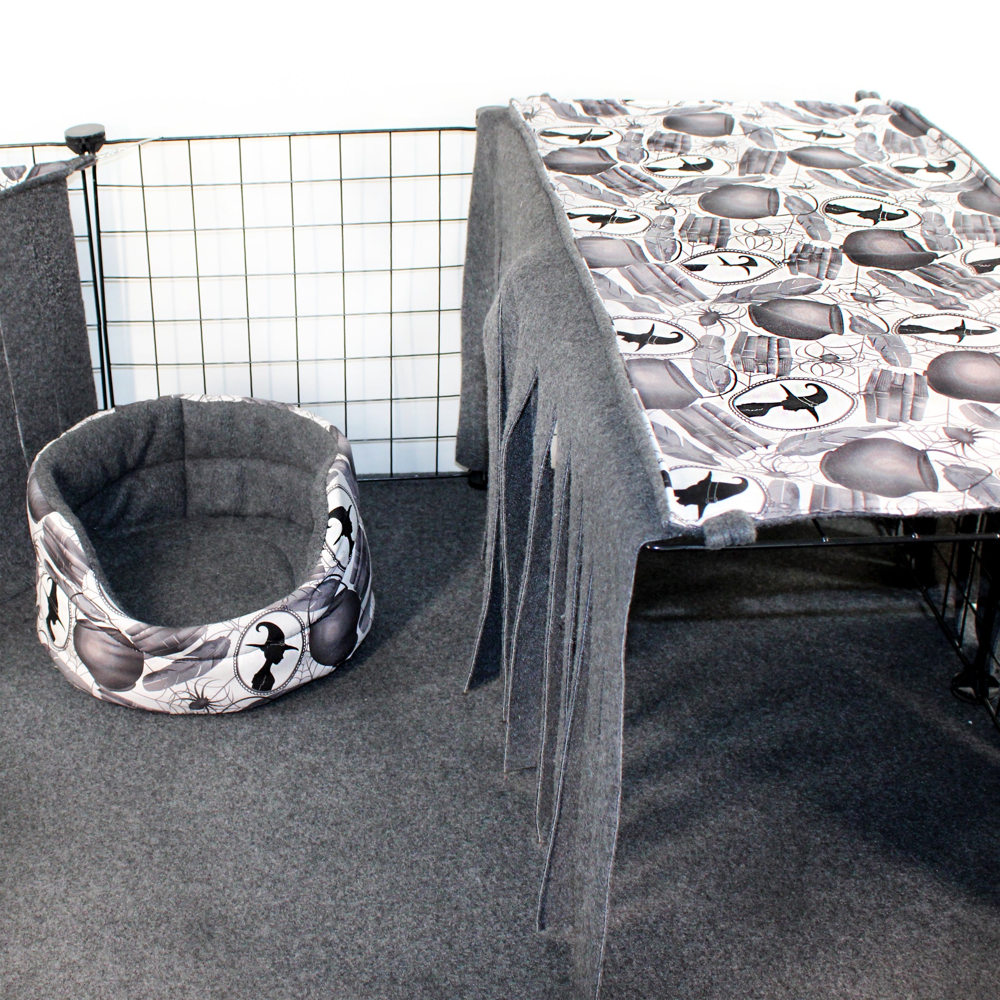 Cat bed with airplane pattern next to a table with a similar pattern in a room setting.