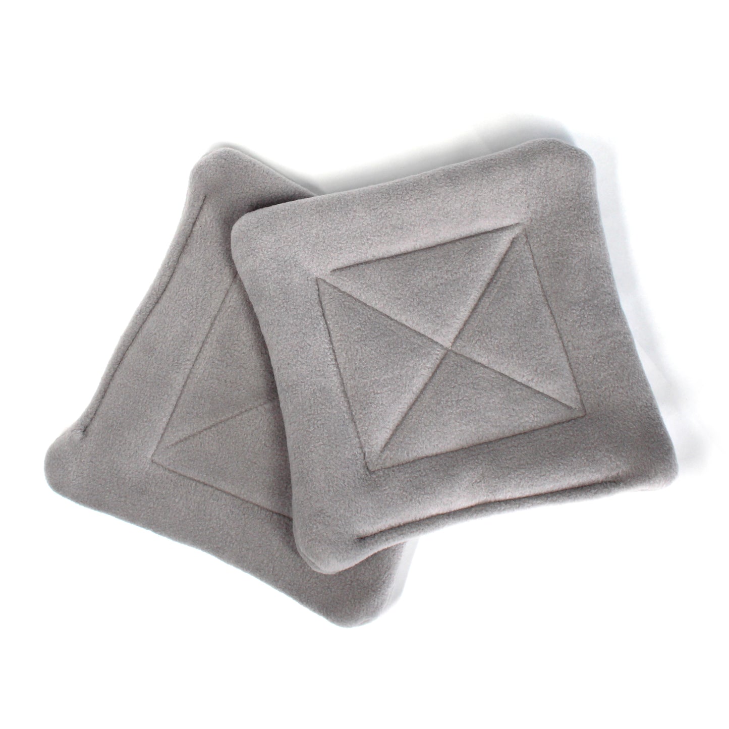 Gray textured pee pads with geometric patterns on a white background