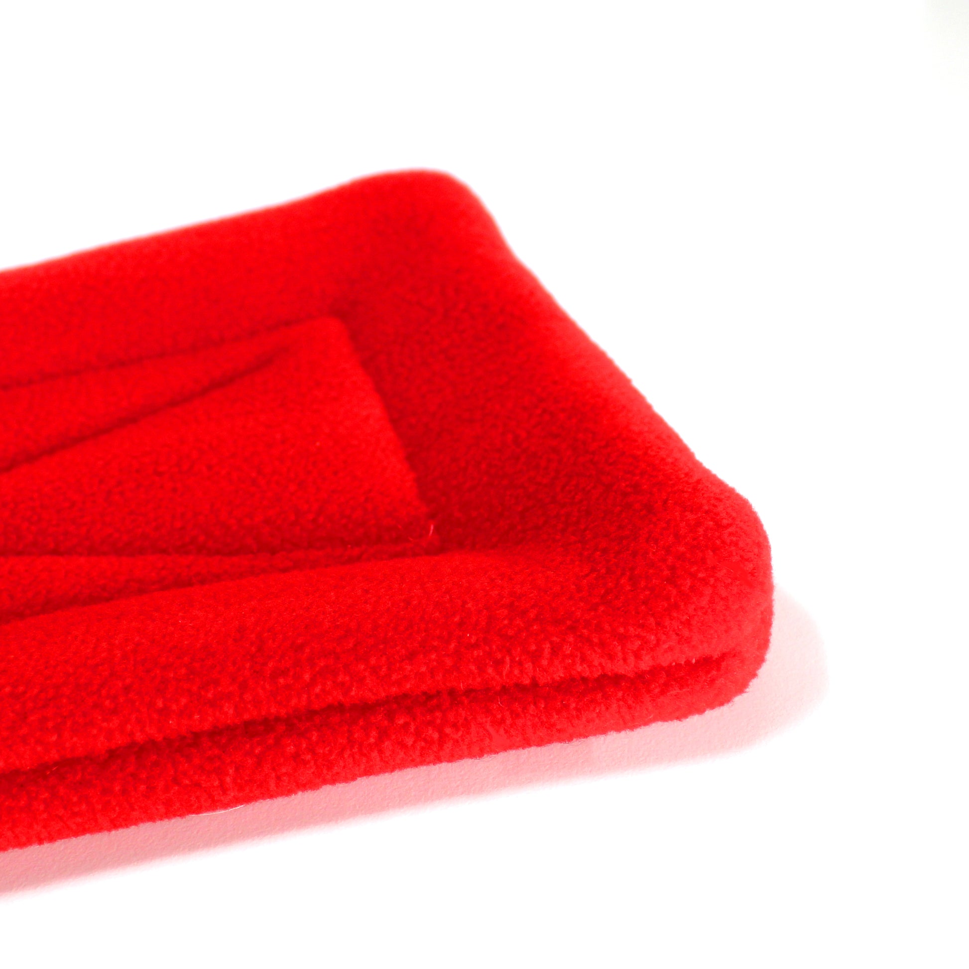 Red And White Christmas Guinea Pig Snuggle Tunnel, close up view of the pee pad