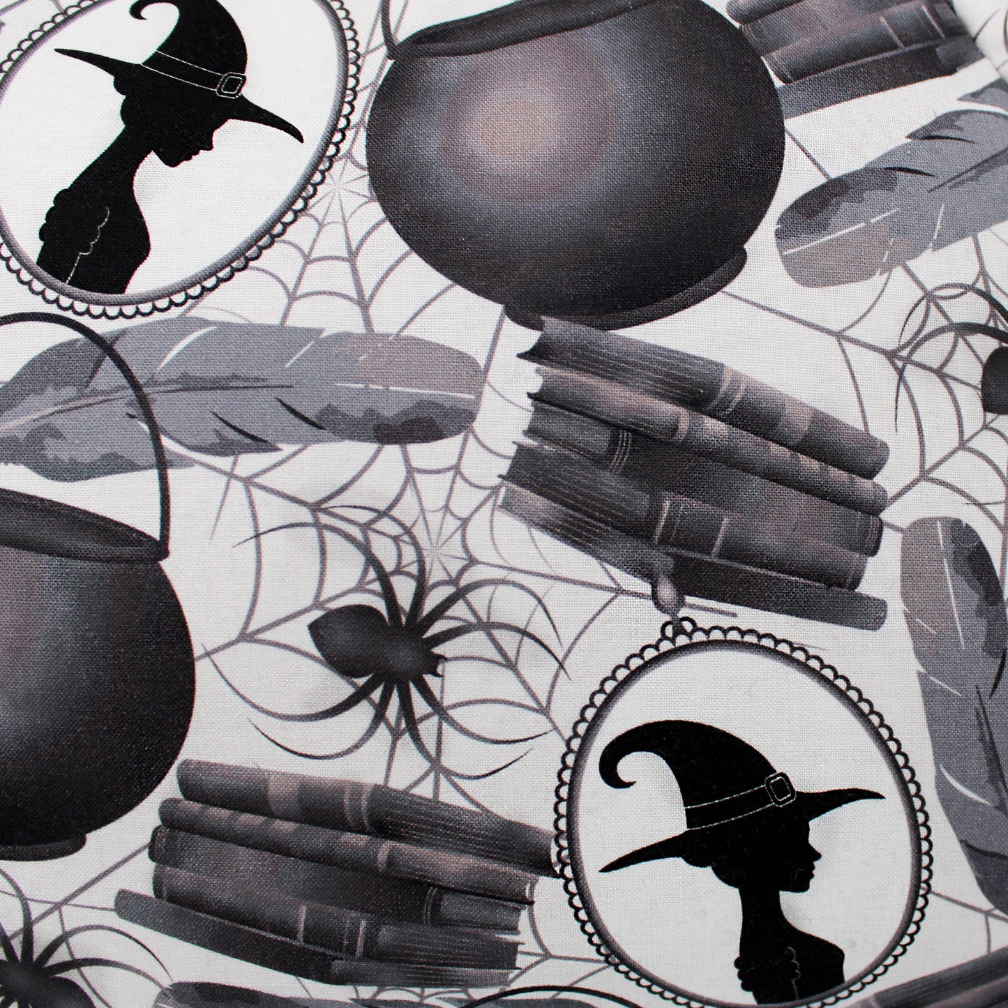 Halloween-themed design with cauldrons, books, and witch hats on a spider web background.