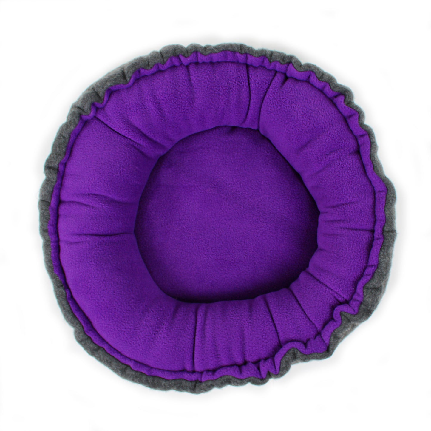 Round pet bed with purple interior and gray exterior on a white background