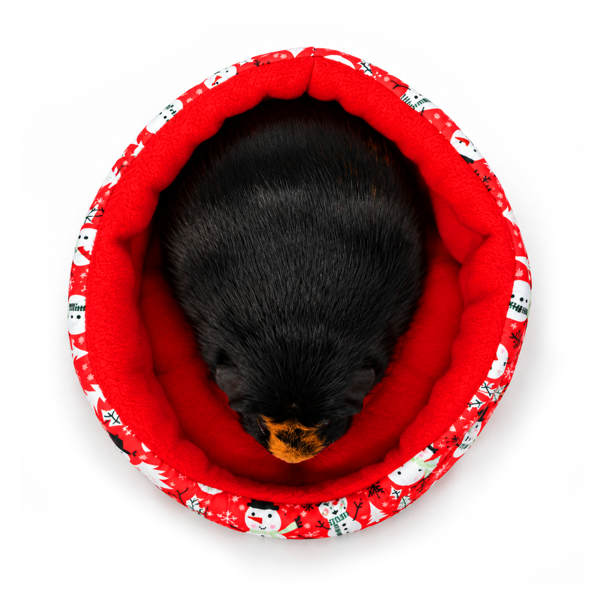 Top-down view of Olive sitting in a red snowman print cuddle cup with a cosy red fleece lining