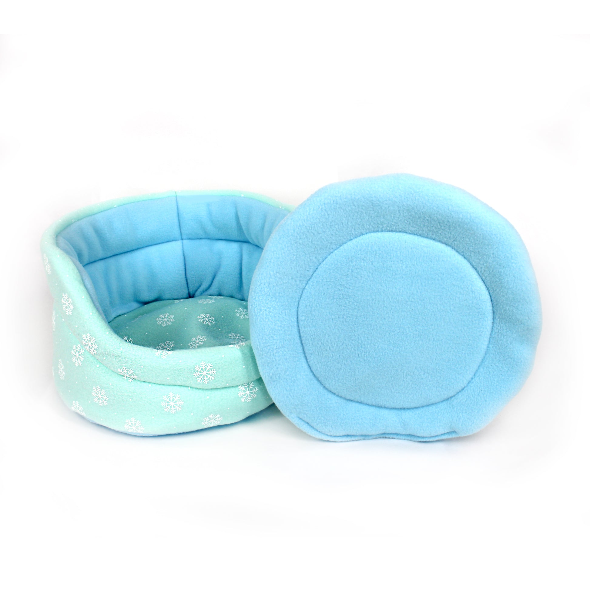 Light blue pet bed with snowflake pattern on a white background