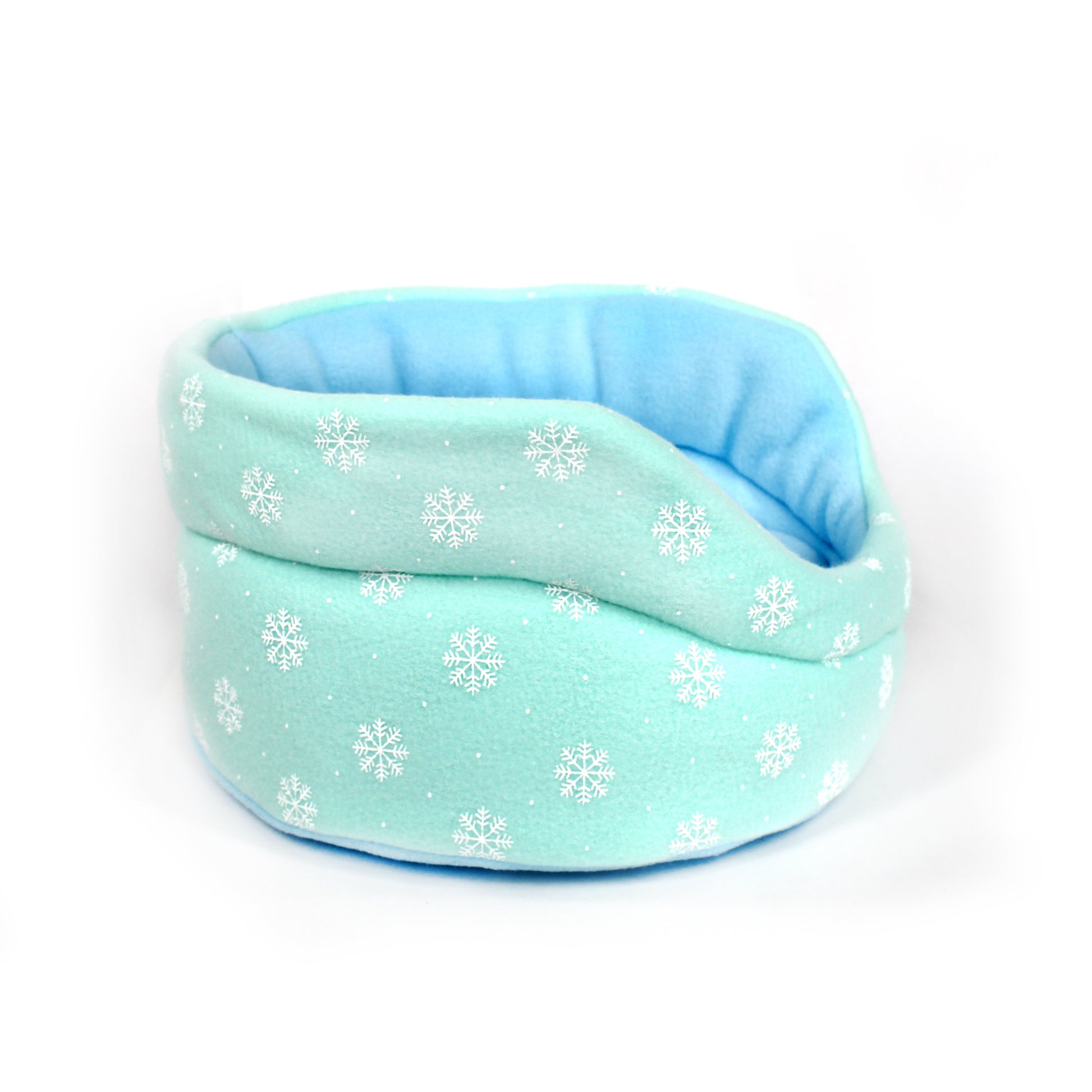 Light blue pet bed with snowflake pattern on a white background