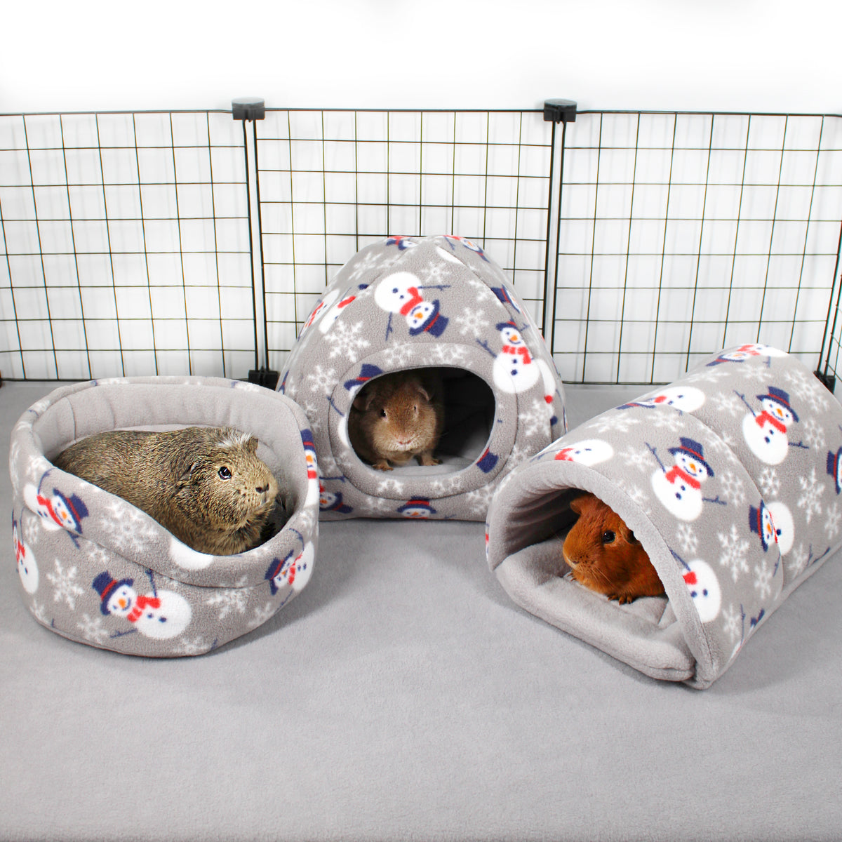 Grey Snowman guinea pig hidey house with matching festive fleece accessories in a cage
