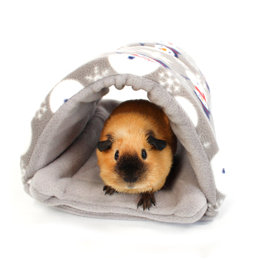 Guinea pig peeking out from a Gray fabric tunnel with colourful snowman patterns on a white background