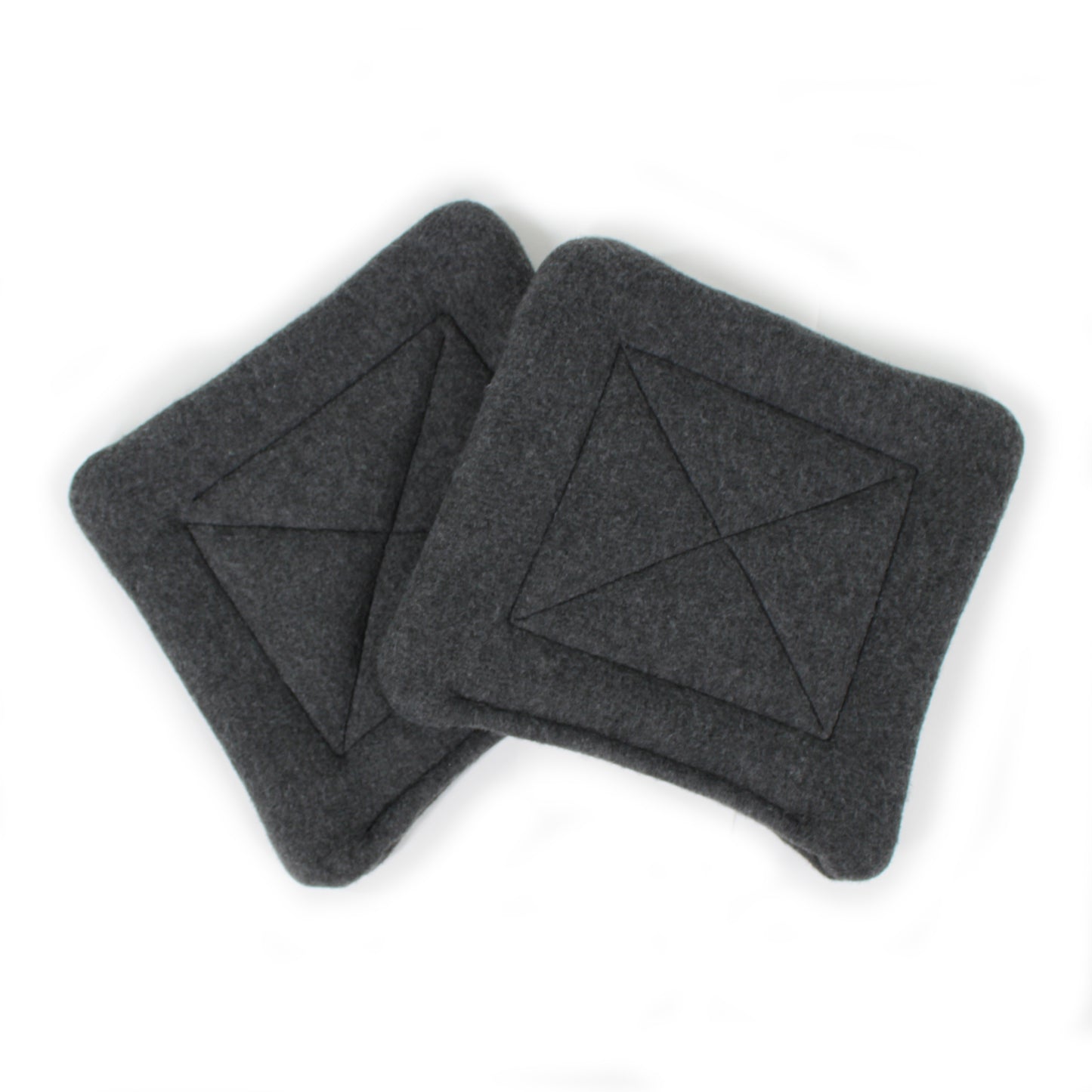 Two dark gray square pee pads with a geometric pattern on a white background