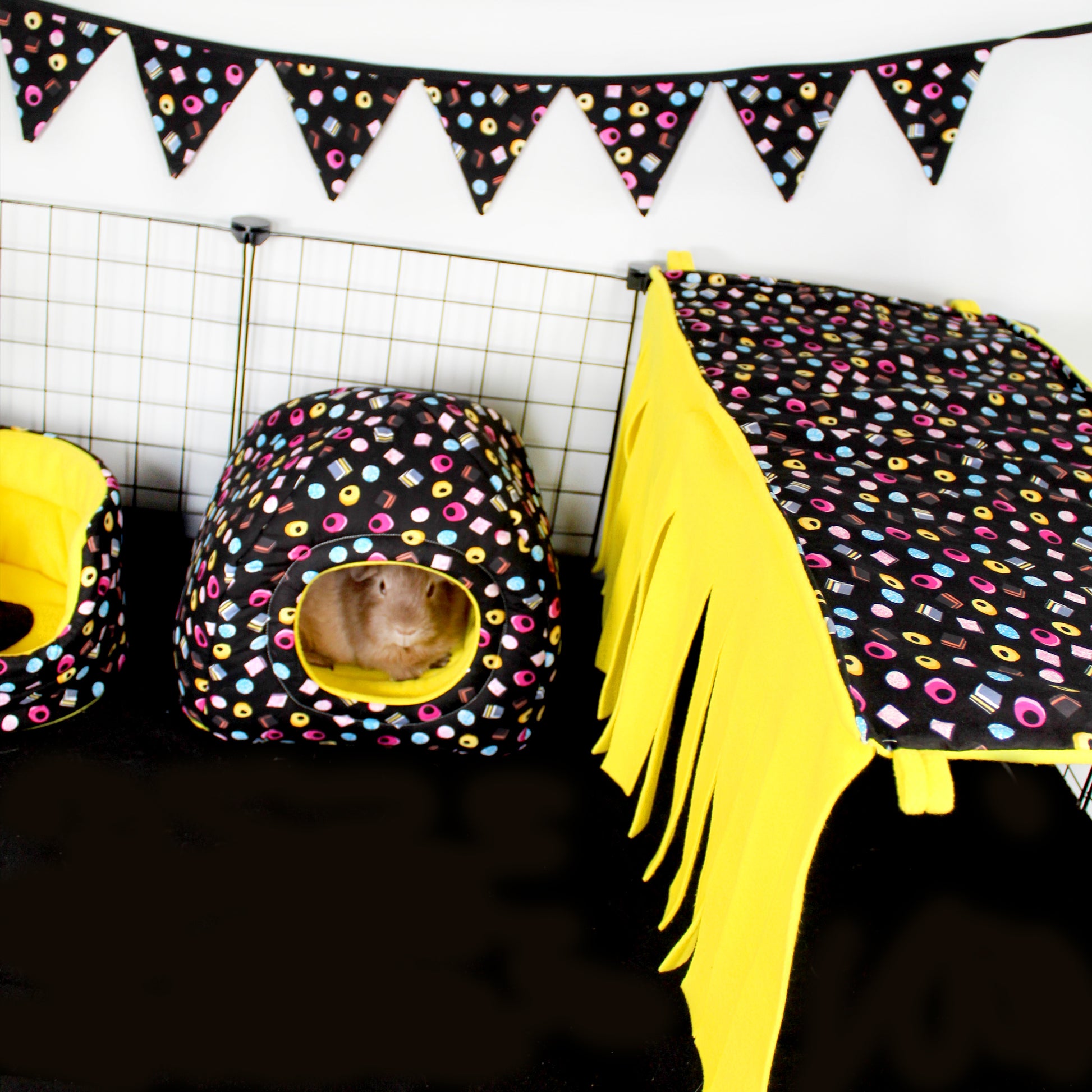 Liquorice Allsorts Large Fleece Forest, set up in a cage with other liquorice allsorts themed guinea pig fleece accessories