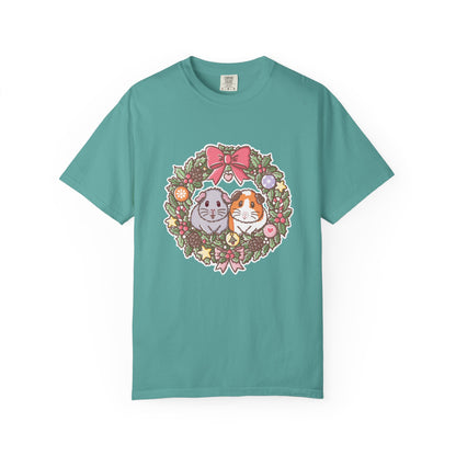 Seafoam green Christmas T-shirt with an illustrated guinea pig wreath featuring Earl Grey and Teacake.