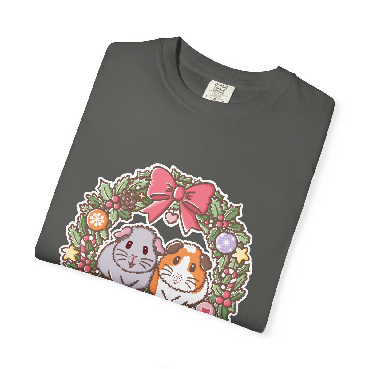 Folded Pepper T-shirt showing the colourful Christmas guinea pig wreath print.