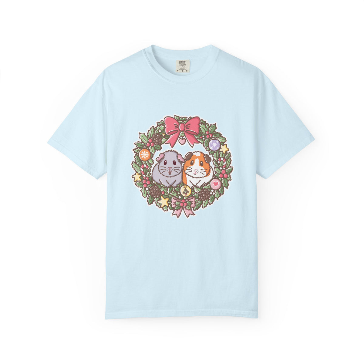 Light blue Christmas T-shirt featuring a festive guinea pig wreath illustration.
