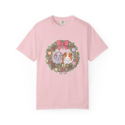 Pale pink Comfort Colors T-shirt featuring Earl Grey and Teacake guinea pigs inside a festive Christmas wreath illustration.