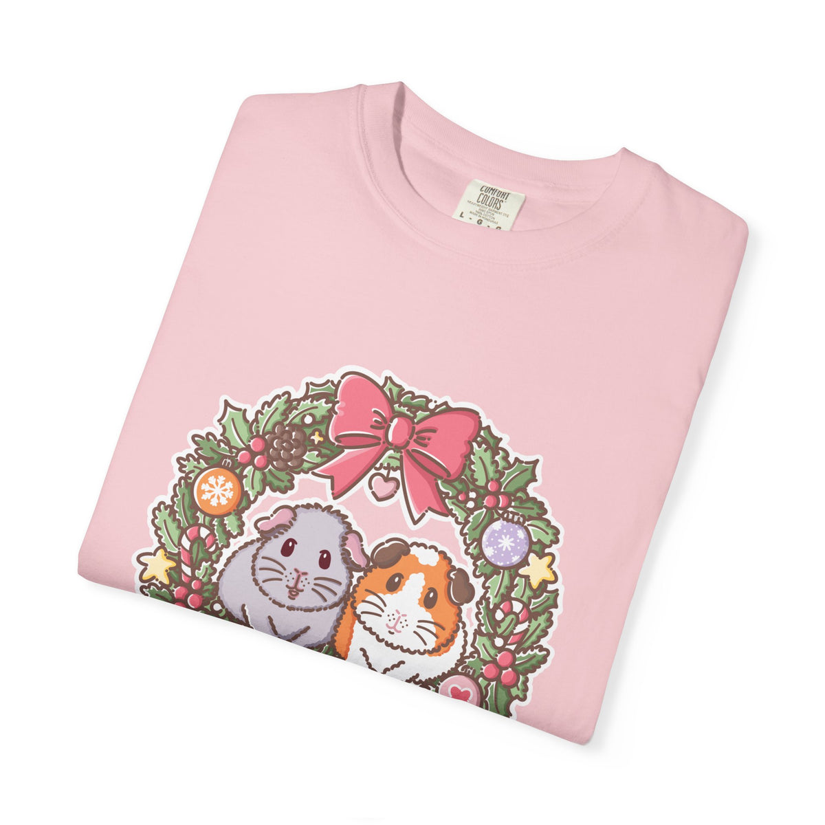 Folded pale pink T-shirt displaying the Earl Grey and Teacake Christmas wreath design.