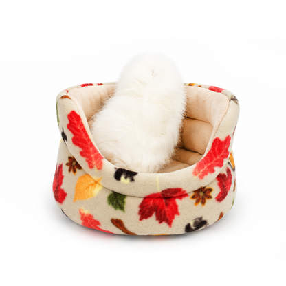 Guinea pig sitting in an Autumn Beige Cuddle Cup with pumpkin and leaf fleece print