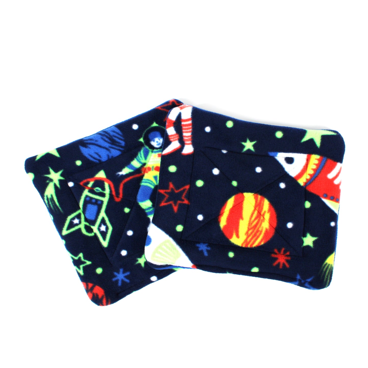 Pair of pee pads with space-themed design on a white background