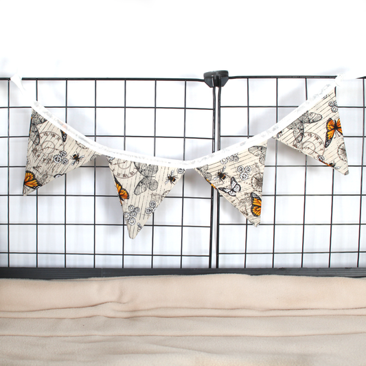 Small Steampunk Butterfly Bunting, hung from a guinea pig cage