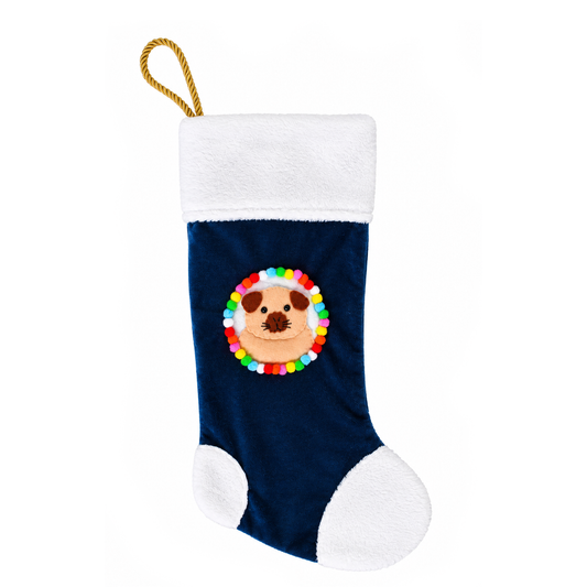 Handmade cream Californian guinea pig Christmas stocking with navy blue recycled velvet, soft white cuddle fleece trim, felt guinea pig decoration with dark markings, colourful pom-poms and gold rope hanging loop.
