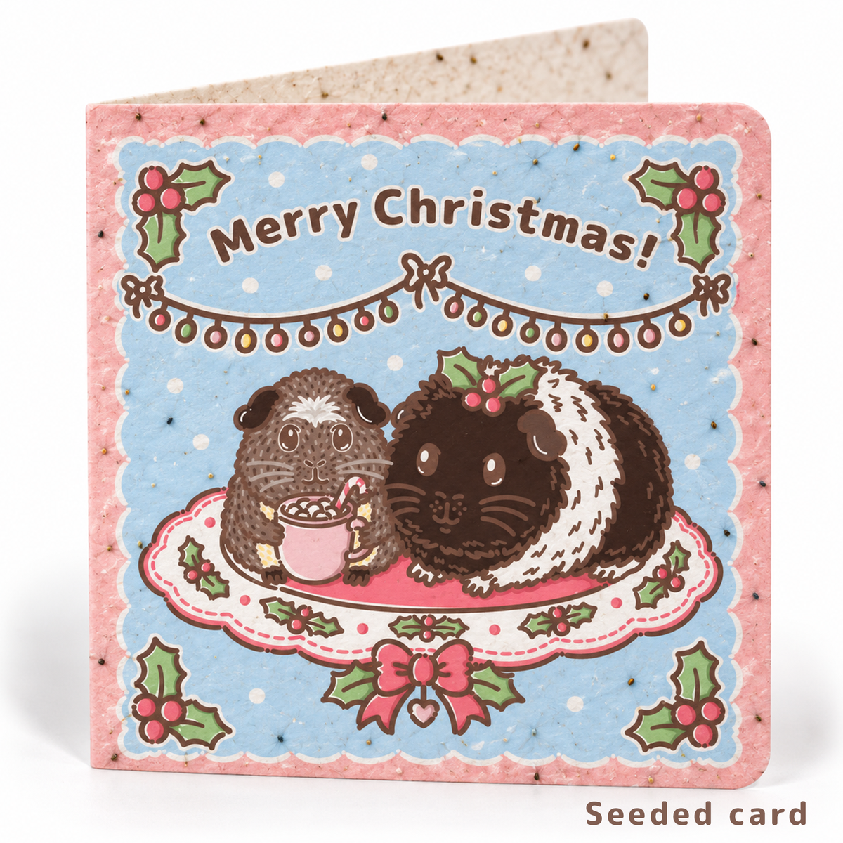 Seeded Christmas guinea pig card featuring Twiglet and Pudding with visible wildflower seeds in the paper
