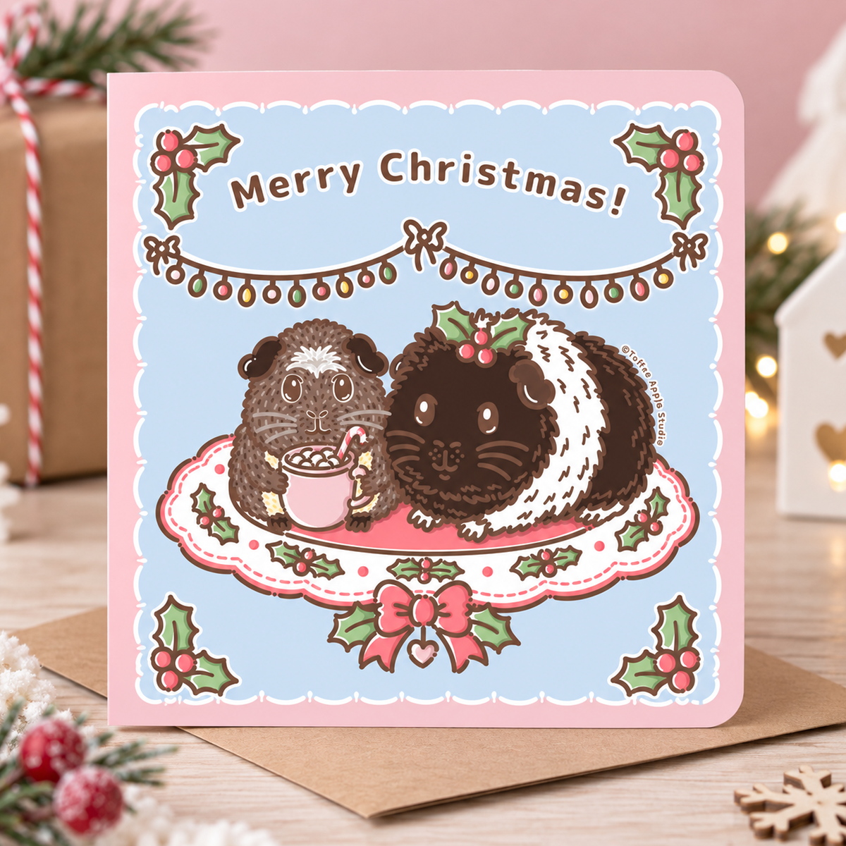 Christmas guinea pig card featuring Twiglet and Pudding together on a festive cushion