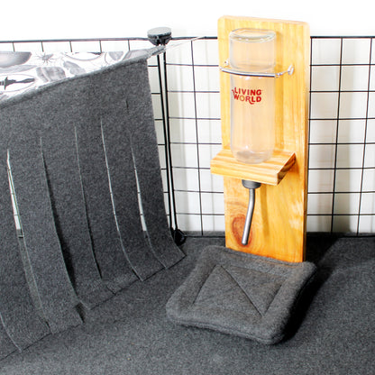 Gray pet mat with a wooden pet stand and glass on a tiled floor.