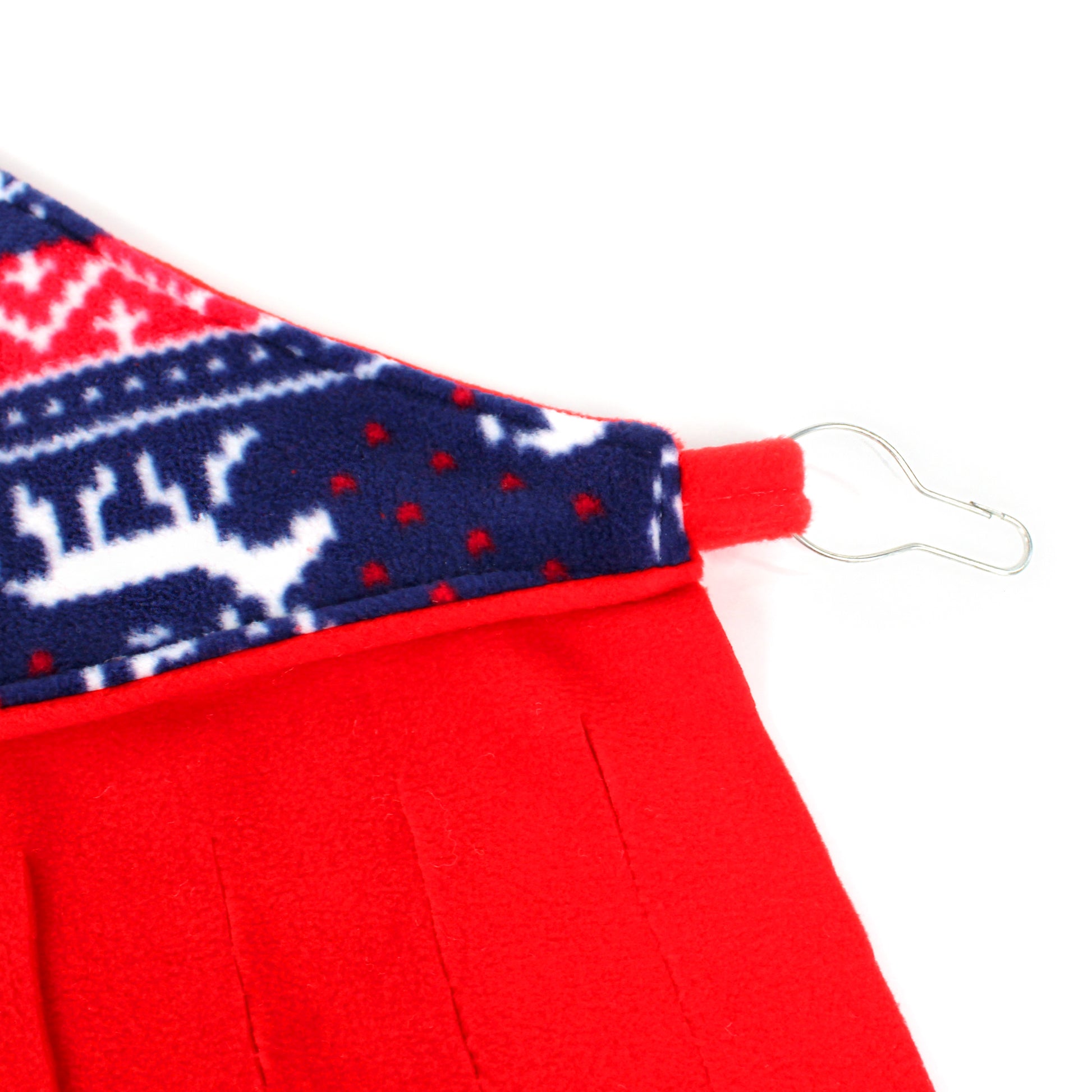 Close-up of a red garment with a patterned trim on a white background