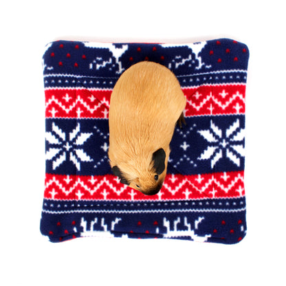Small animal peeking out from a blue and red patterned pouch on a white background