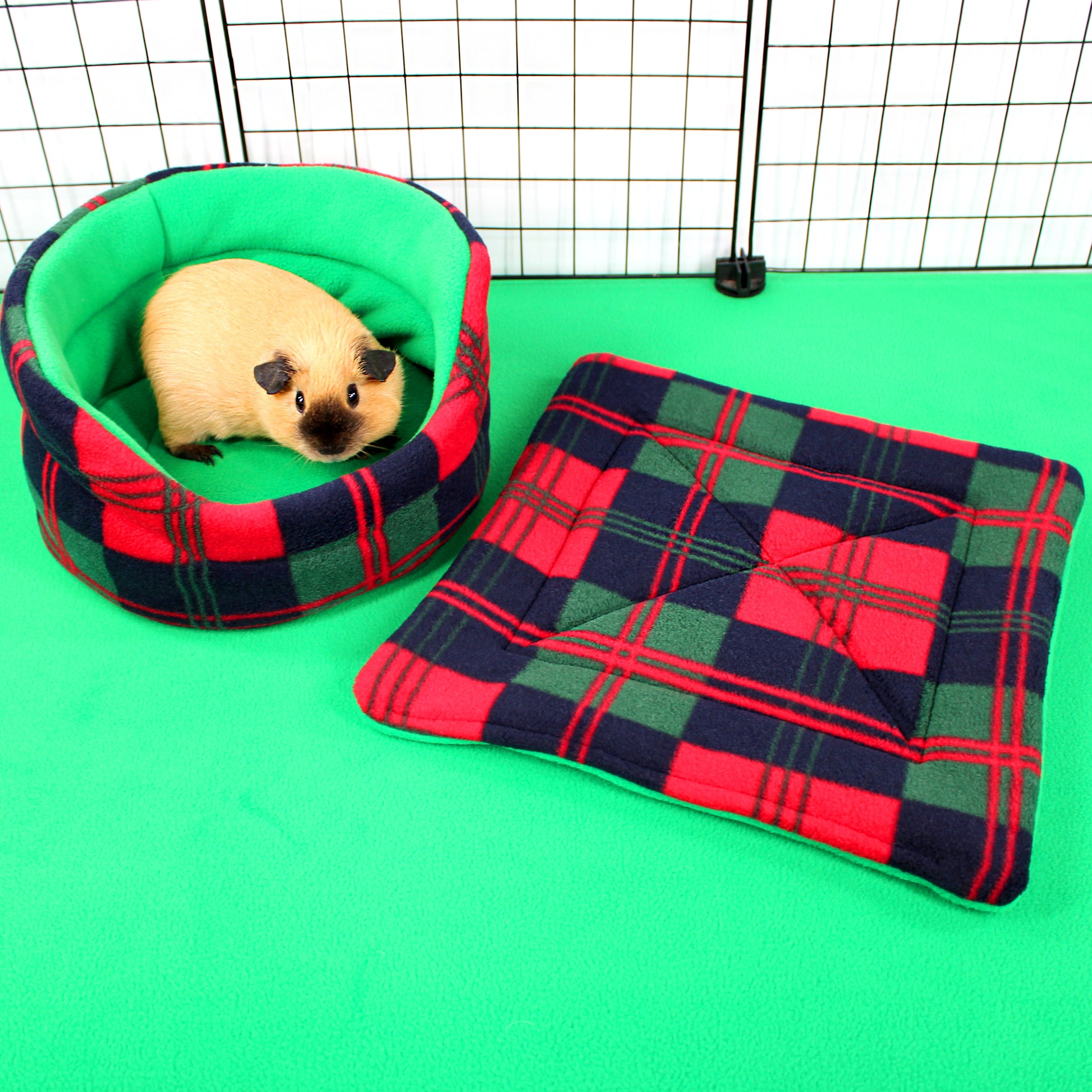 Pet bed with plaid pattern on a green surface