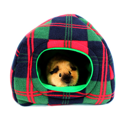 Small animal peeking out from a plaid pet house with green interior on a white background