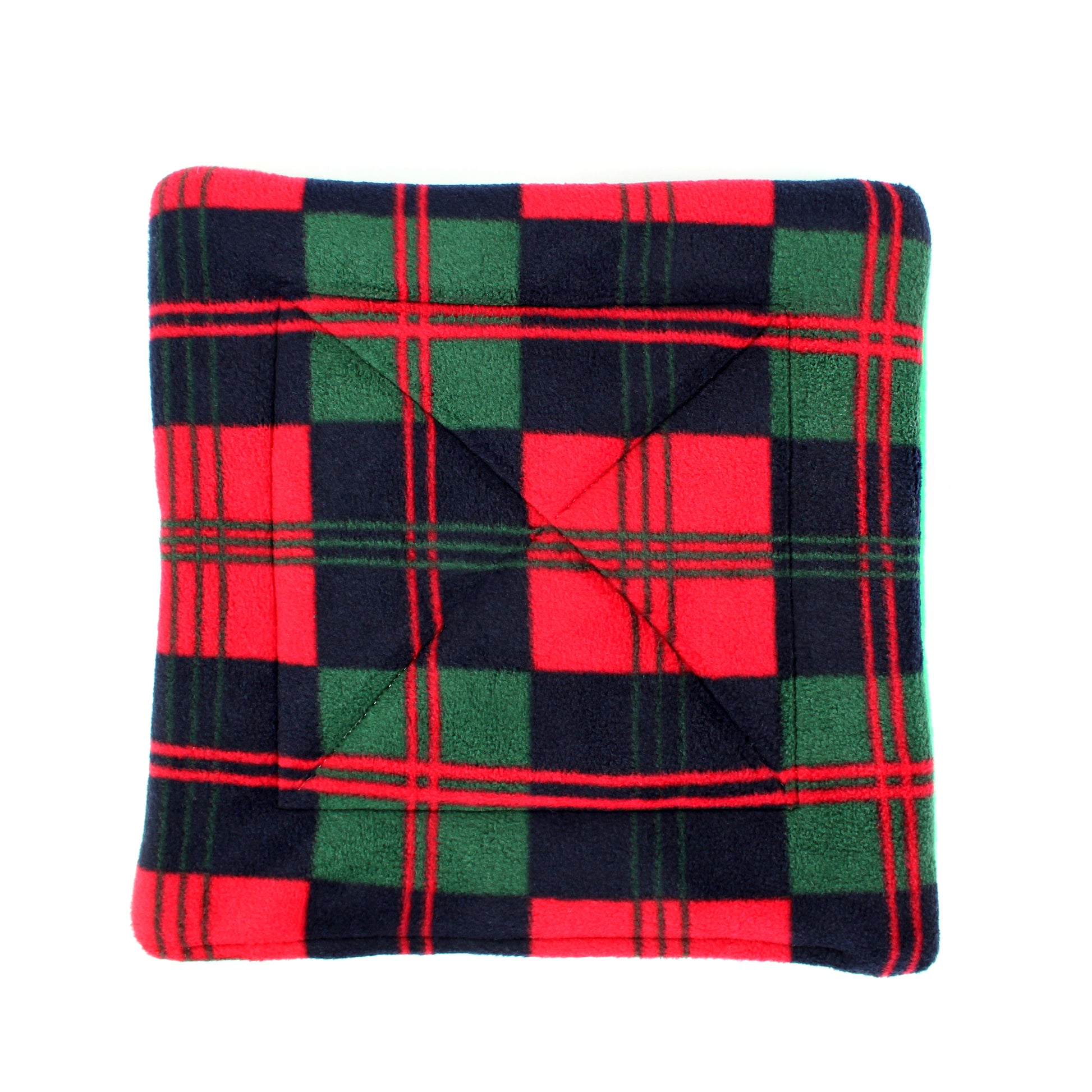 Folded plaid blanket with red, green, and black colours on a white background