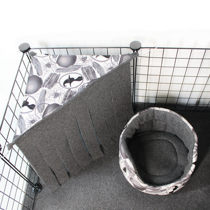 Cat bed with a patterned mat inside a wire cage