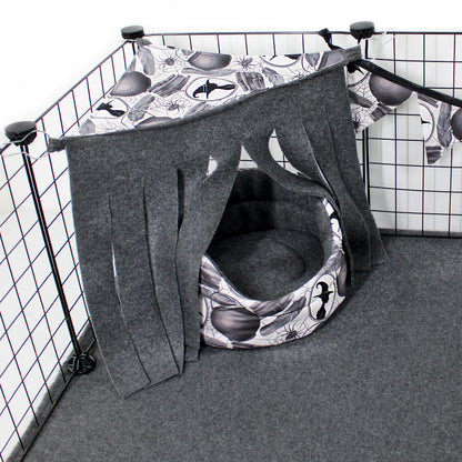 Pet playpen with a gray and black patterned tent inside, on a grid background.