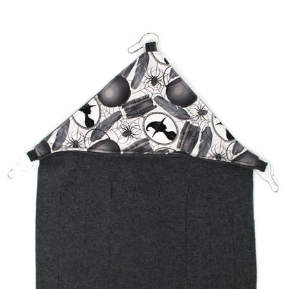 Black and white patterned headscarf with a plain black bottom half on a white background