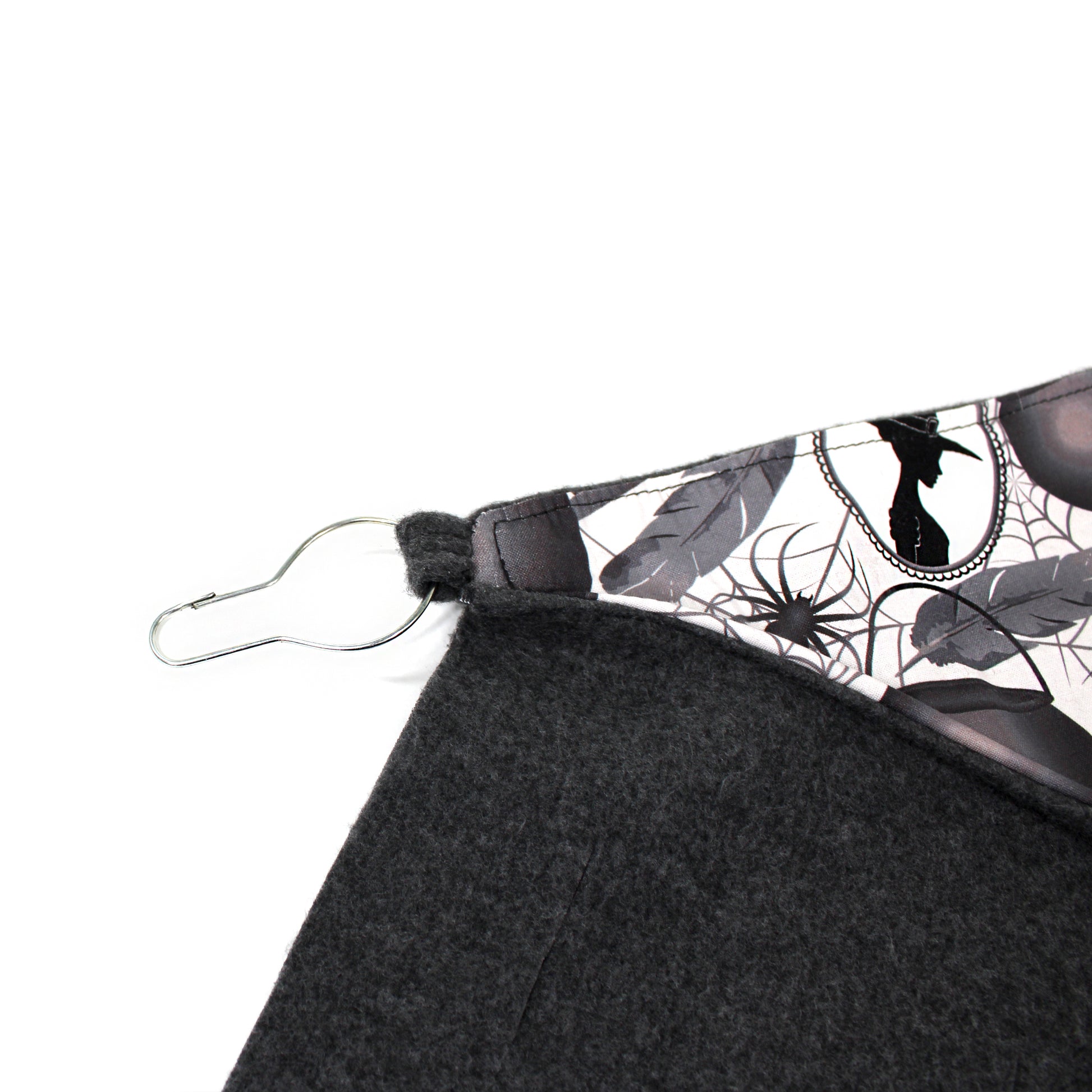 Black fabric with a spider web pattern on a white background