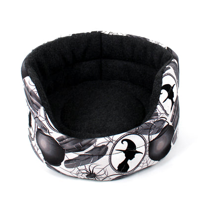 Halloween-themed pet bed with black and white design on a white background