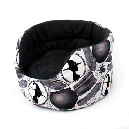 Halloween-themed pet bed with black and white design on a white background