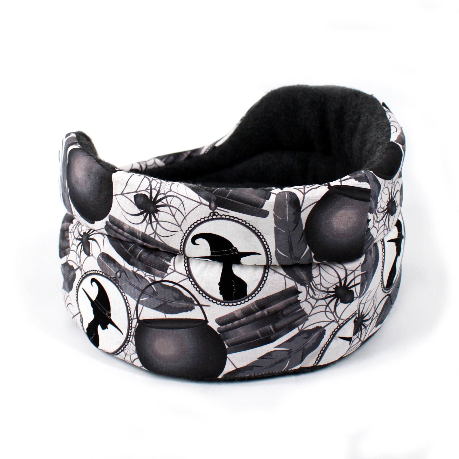 Black and white patterned pet bed with Halloween-themed design on a white background