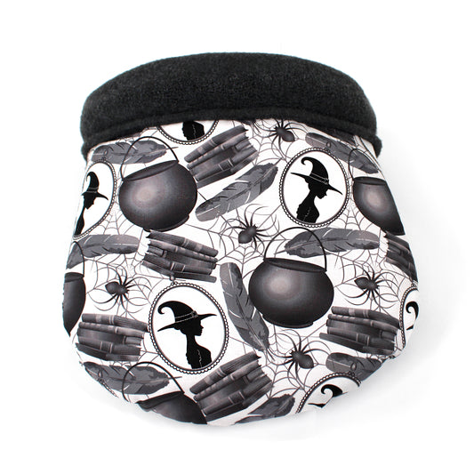 cuddle sack with a Halloween-themed pattern featuring witches, cauldrons, and books on a white background.