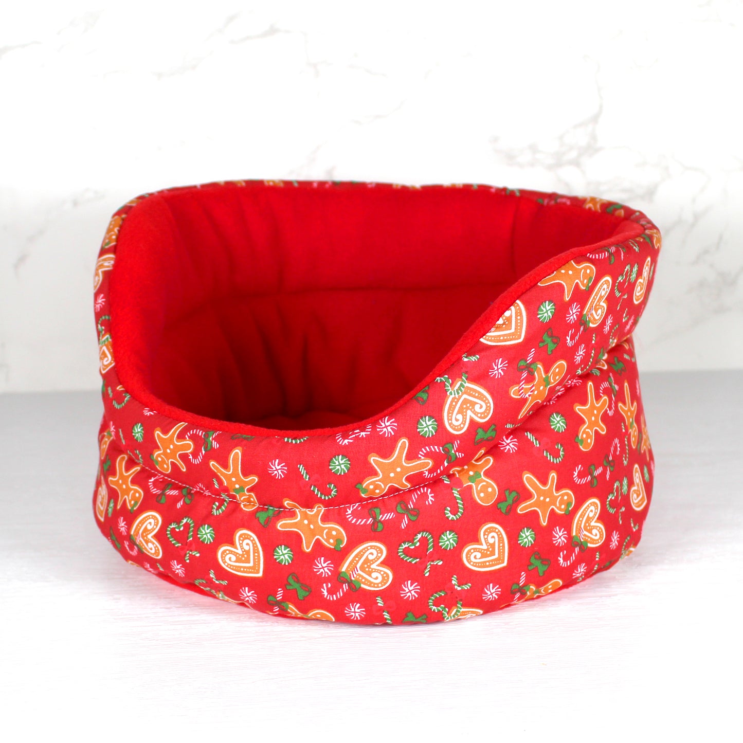 Red Gingerbread Guinea Pig Cuddle Cup, side view of the empty guinea pig bed