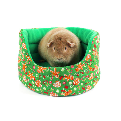 Small animal in a green patterned bed on a white background