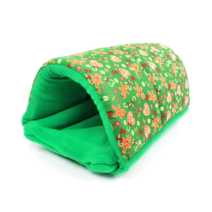 Green pet bed with festive gingerbread man pattern on a white background
