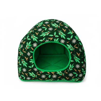 Front view of a Christmas hidey house for guinea pigs featuring a forest green holly print and bright green fleece-lined entrance