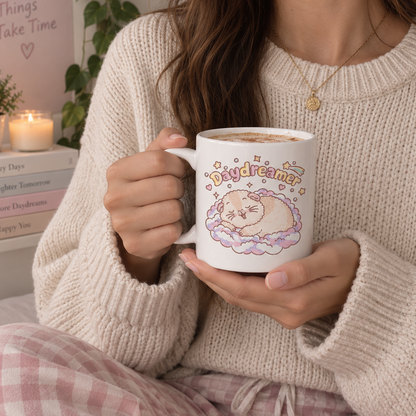 Halloumi Daydreamer guinea pig mug held in hand with a cosy sweater