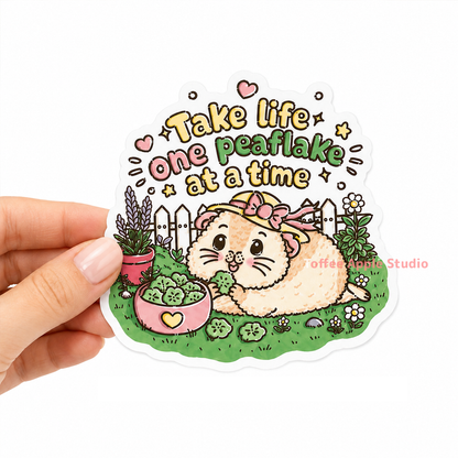 Take Life One Peaflake at a Time guinea pig sticker held in hand