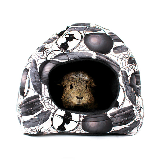 Small animal house with Halloween-themed design featuring a guinea pig inside on a white background